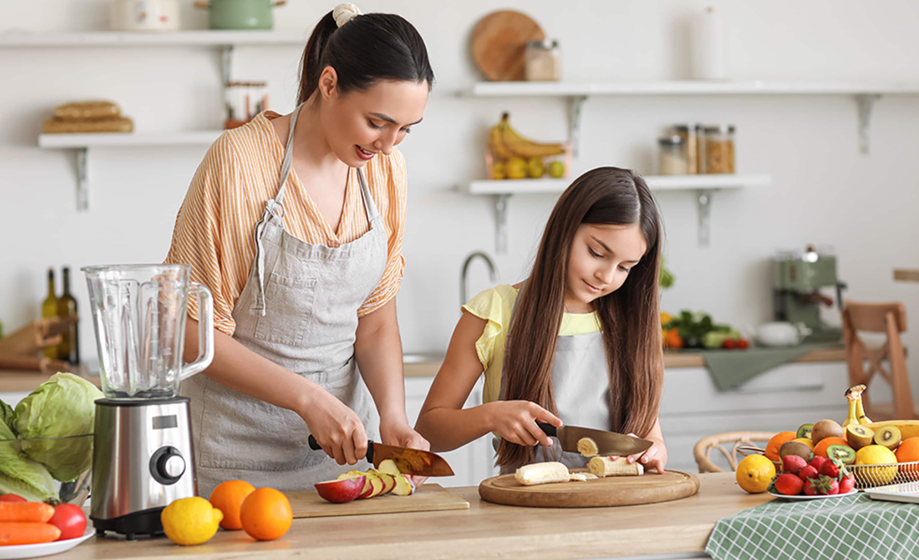 Mom and daughter cutting fruit